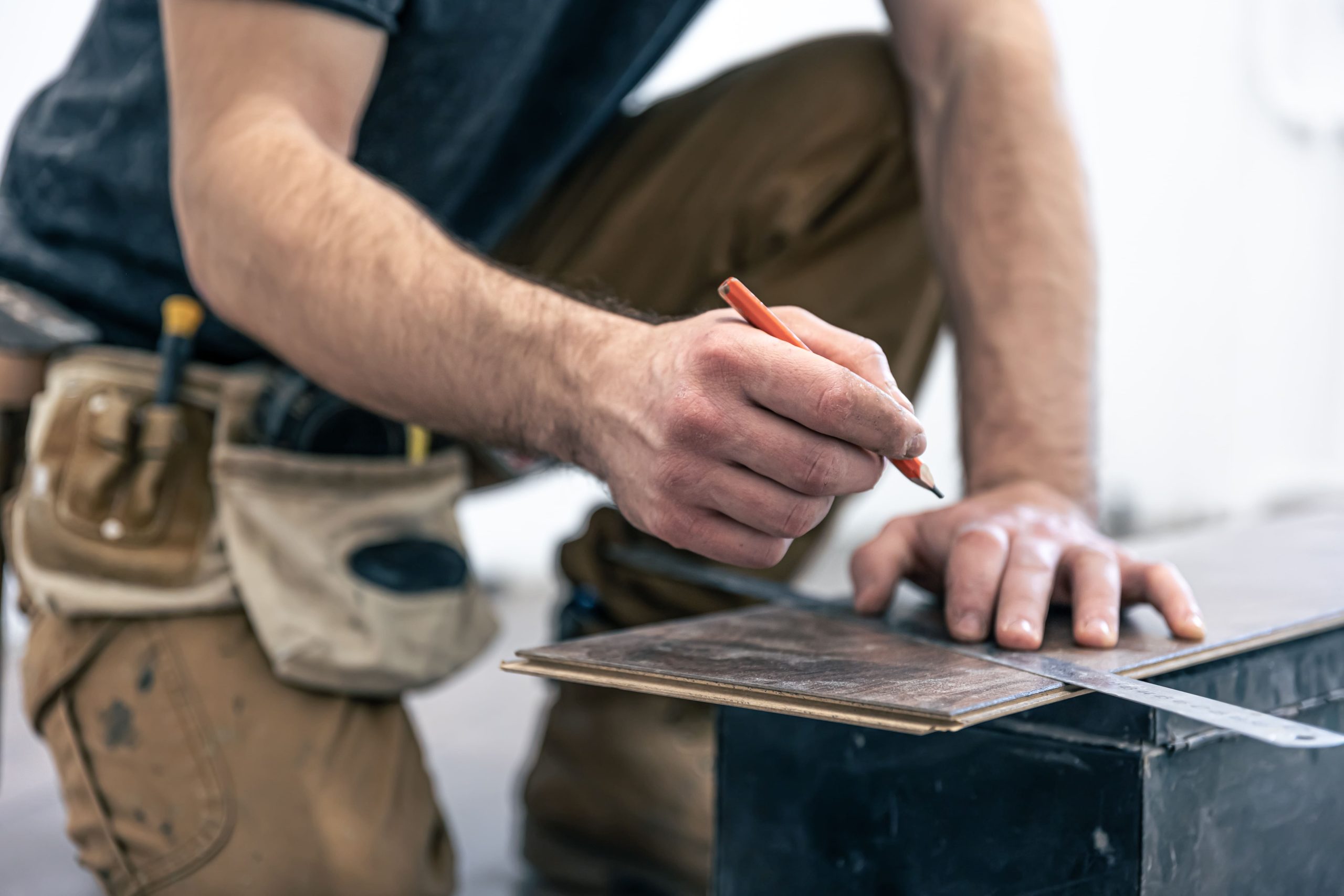 male-worker-puts-laminate-flooring-floor